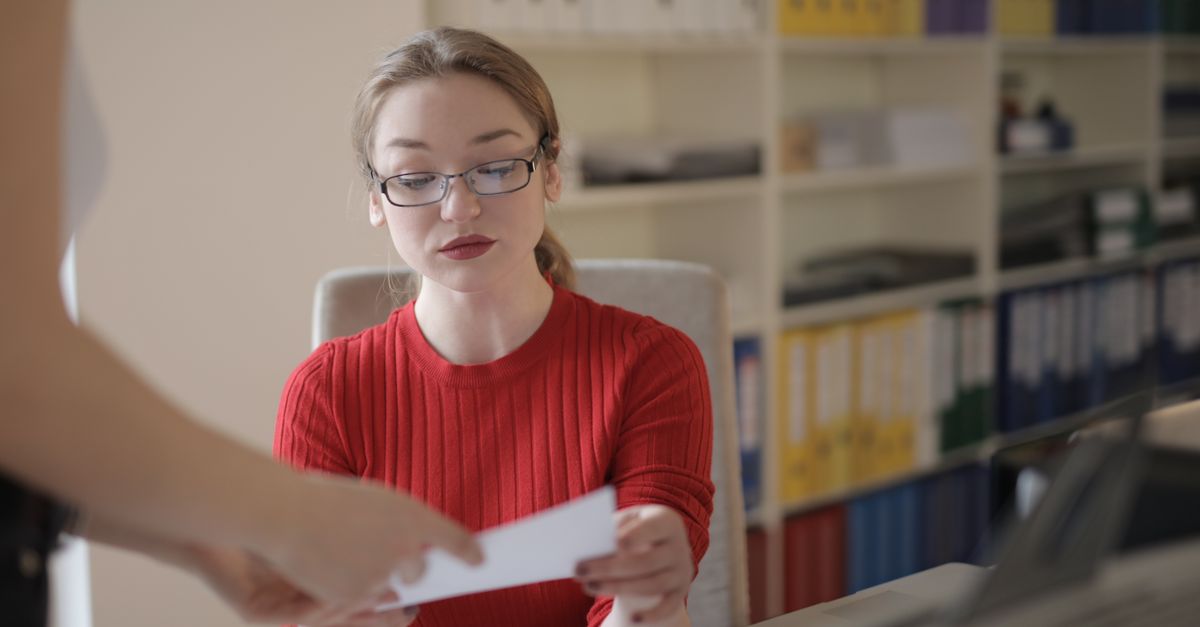 A university administrator working at a desk in a modern office