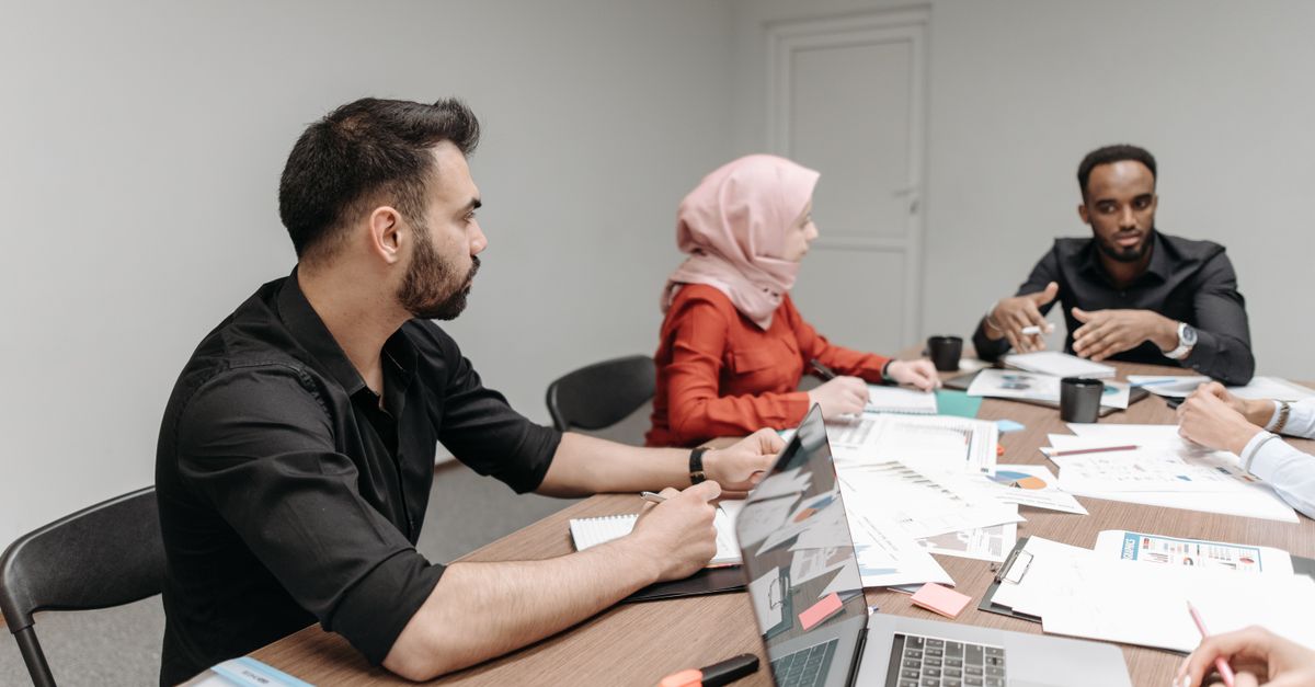 A diverse group of university staff in a collaborative meeting